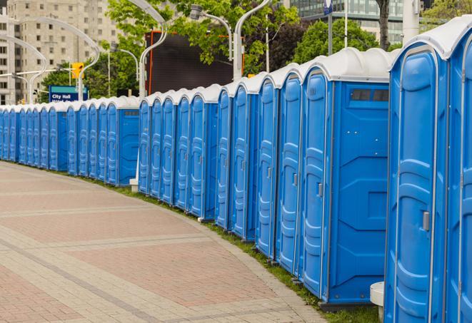 a row of portable restrooms at a fairground, offering visitors a clean and hassle-free experience in iola
